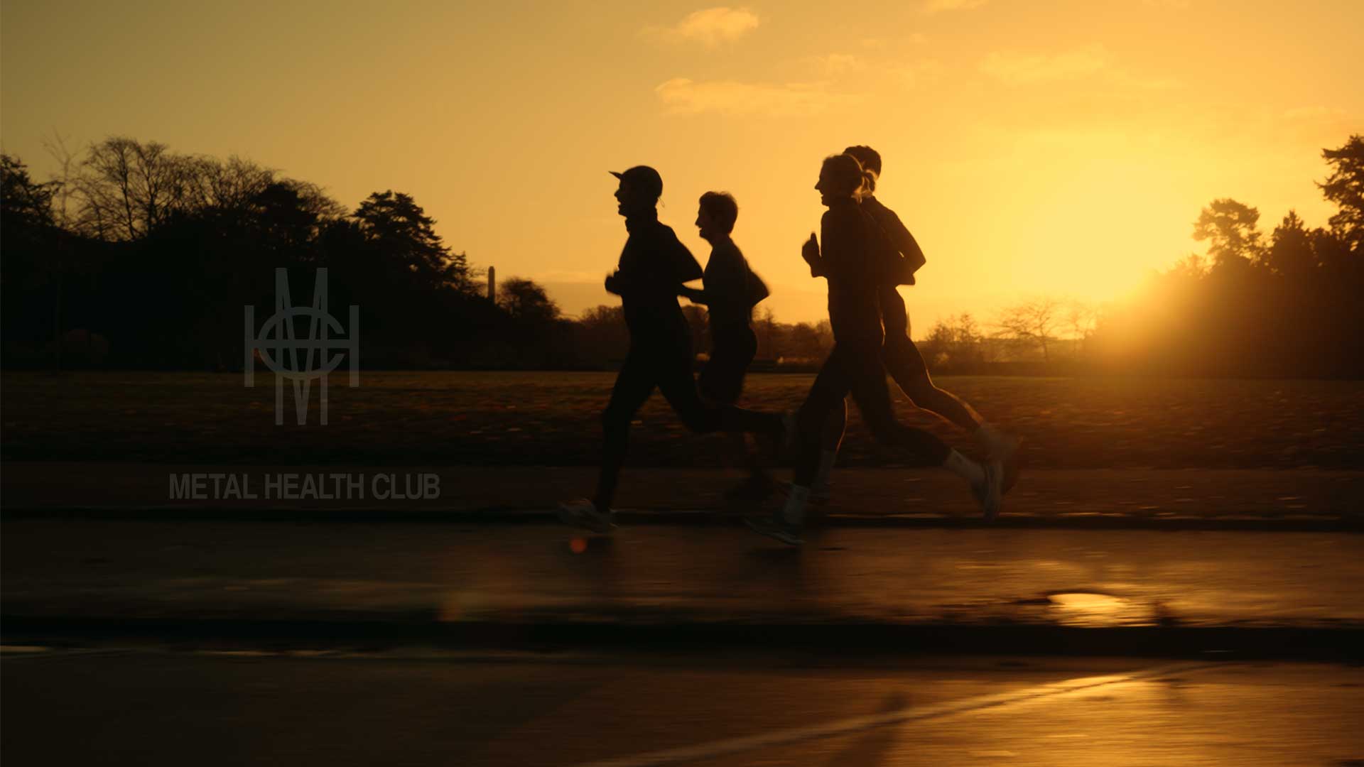 Three runners silhouetted against a sunset sky on a paved path - all runners wearing DOXA RUNNING APPAREL